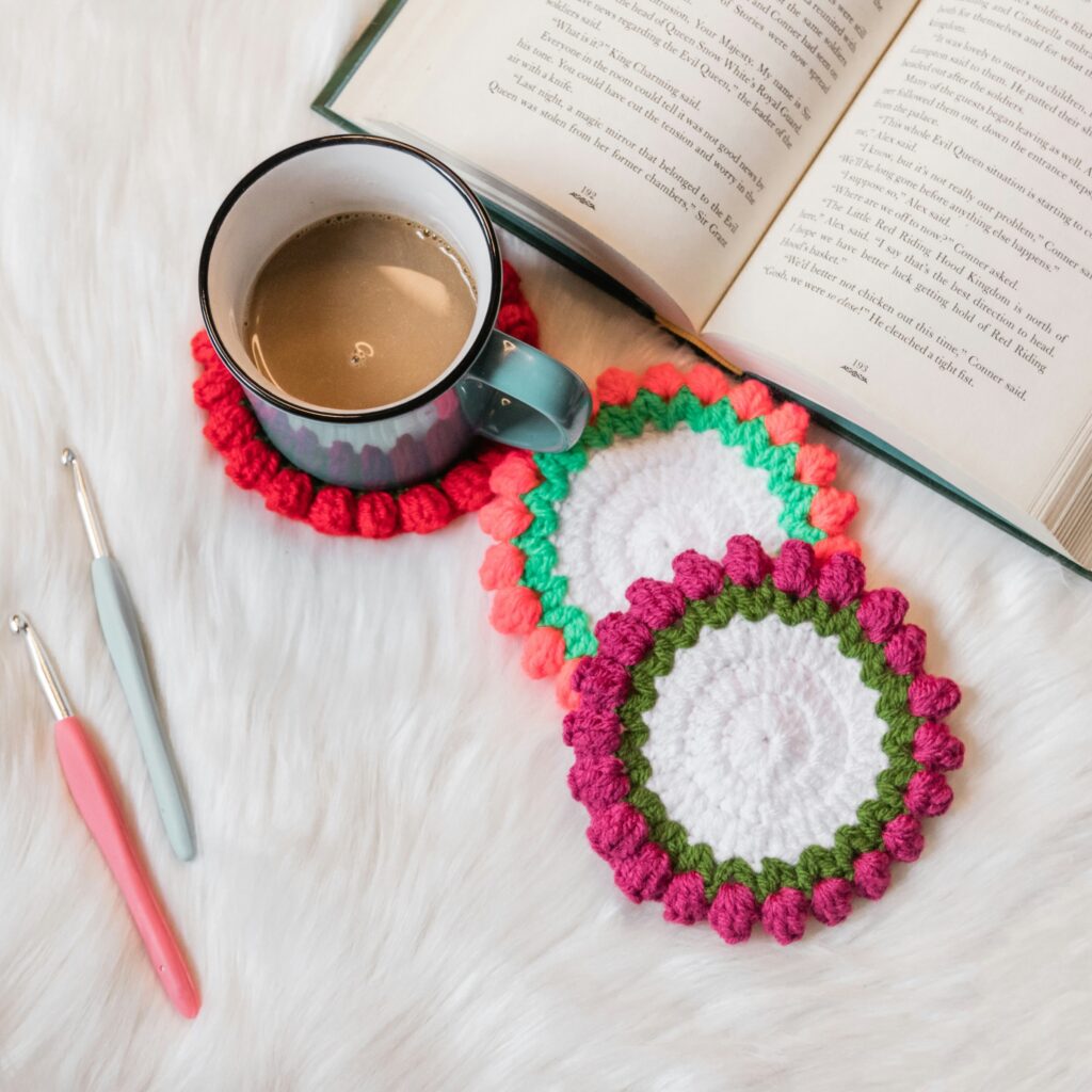 crocheted coasters, mug, and book