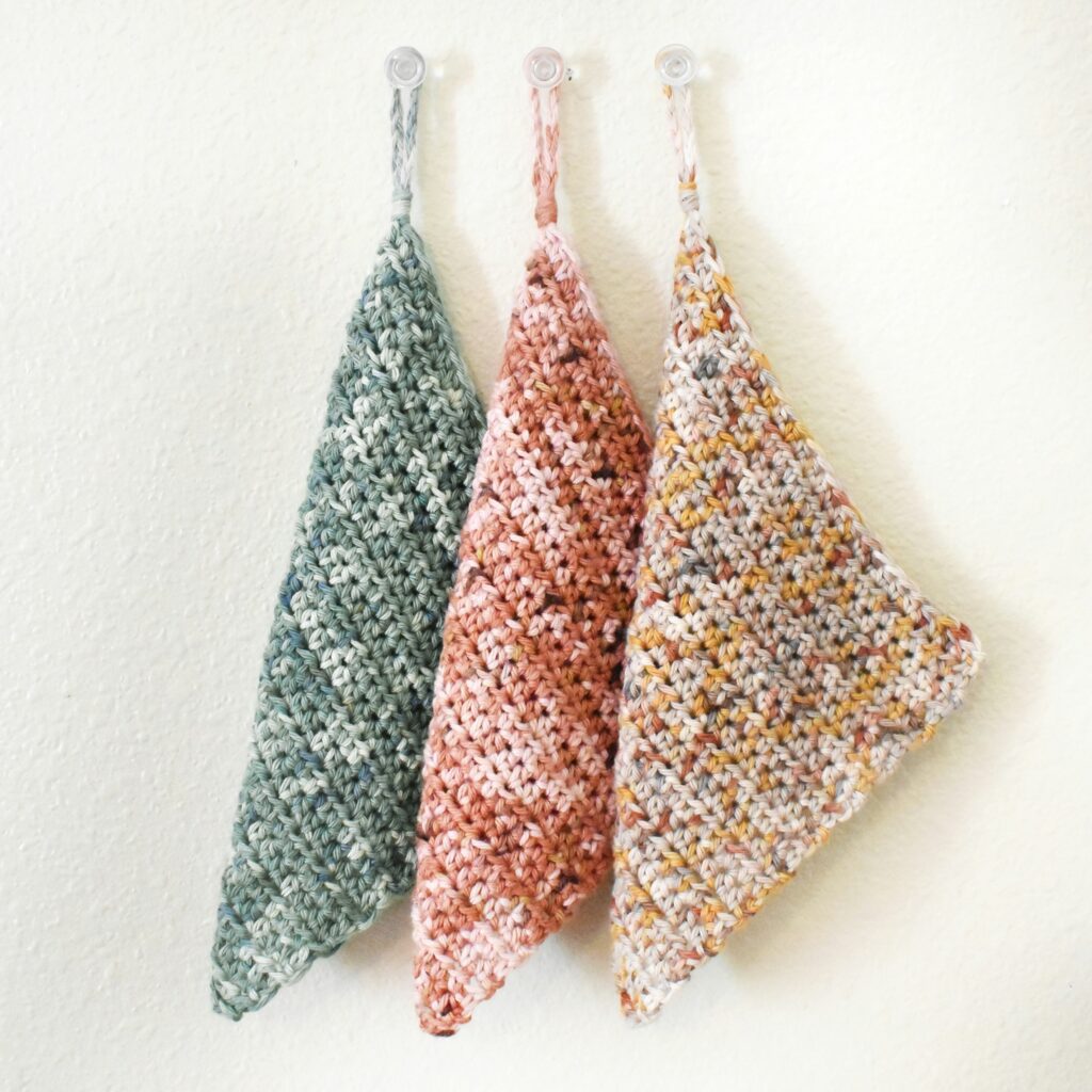 three pot holders on hooks